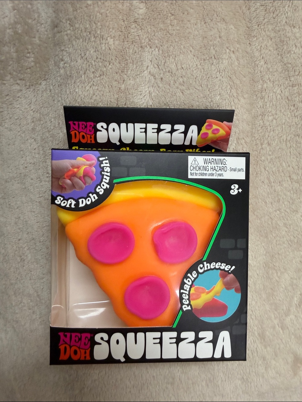 Nee Doh pizza 
 Squeezzza Pizza Squishy Toy - Orange & Pink